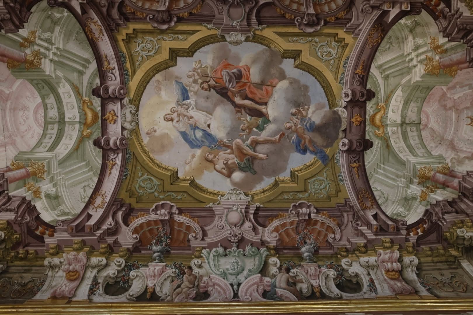 Il riquadro centrale della volta, con figure in gloria tra le nuvole e architetture dipinte